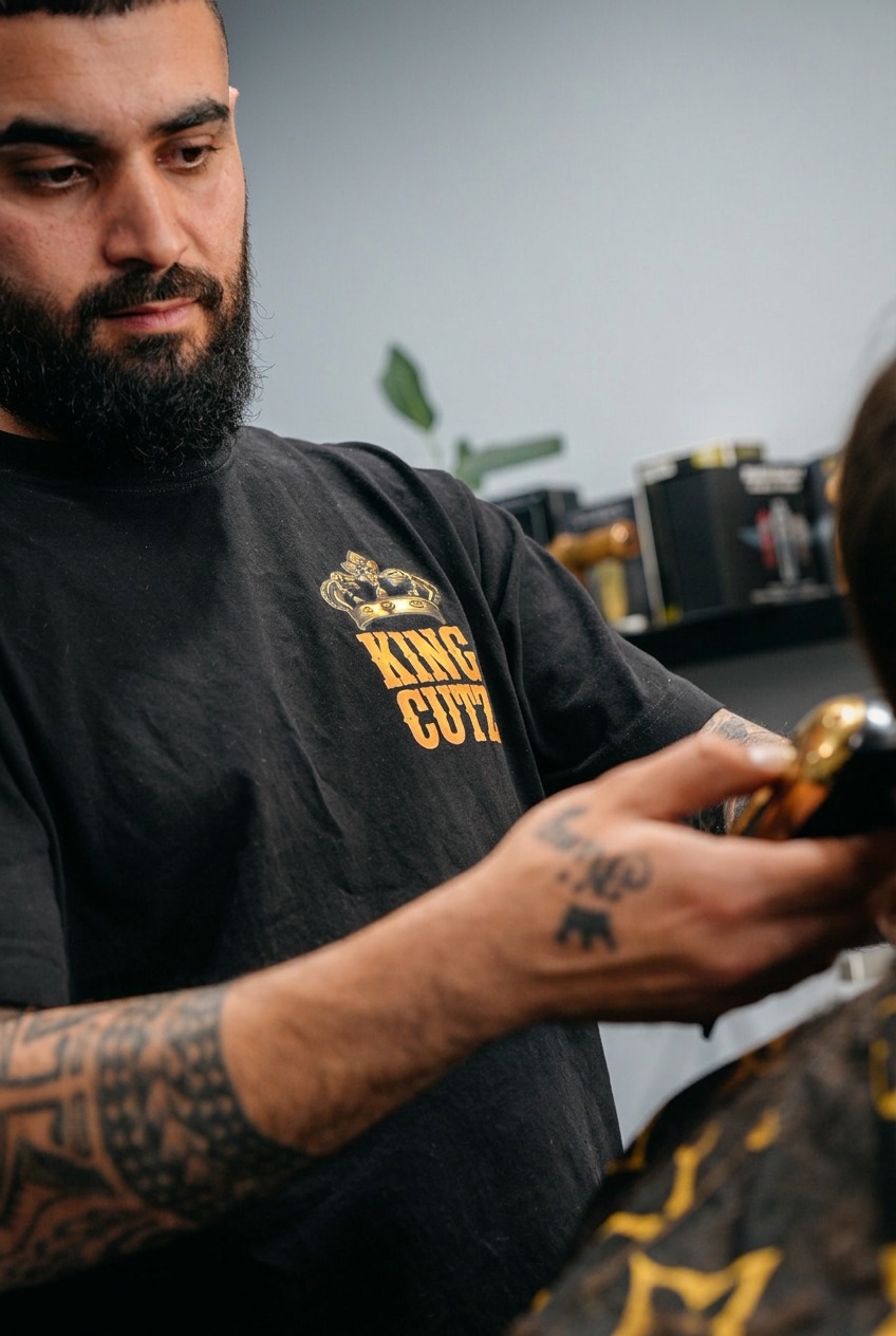 King Cutz barber focused on a client's haircut